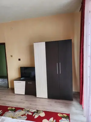 a large cabinet in the corner of a room at Apartment Lachevi in Sandanski