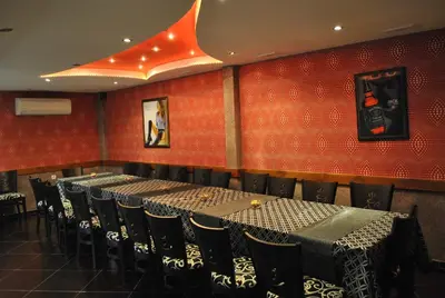 a row of tables and chairs in a restaurant at Family hotel Gradina in Ognyanovo