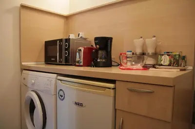 a kitchen with a counter with a washing machine at Apartment 132 in Sofia