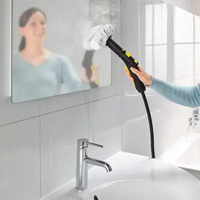 a woman holding a brush in front of a mirror at Apartment 132 in Sofia