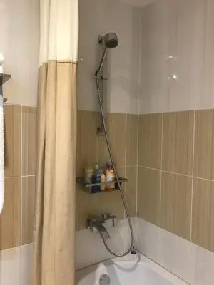 a shower head in a bathroom with a shower curtain at Iceberg Apartment 50 in Borovets