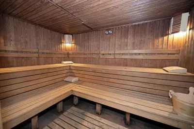 a large wooden sauna with wooden benches in it at Iceberg Apartment 50 in Borovets