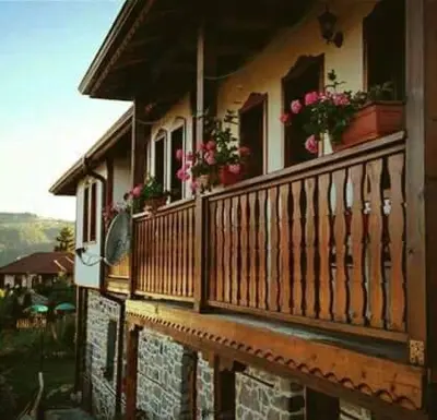a balcony of a house with flowers on it at Semana Guesthouse in Vrata