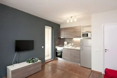 a living room with a kitchen with a tv at Sofia Top Apartments in Sofia
