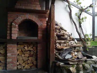 a brick oven with a pile of fire wood at Deny Holiday home in Dobrinishte