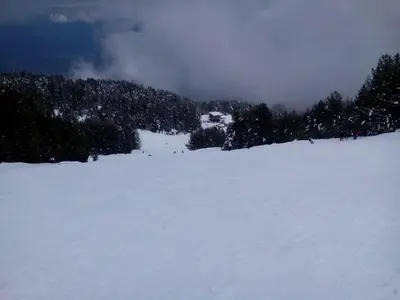 a group of people skiing down a snow covered slope at Deny Holiday home in Dobrinishte