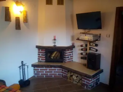 a living room with a brick fireplace with a tv at Deny Holiday home in Dobrinishte