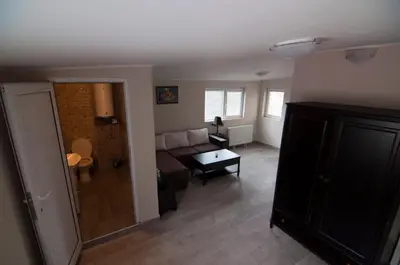 a living room with a couch and a table at Snow Heaven Hotel in Bankya