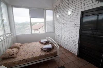 a bedroom with a bed and a large window at Snow Heaven Hotel in Bankya