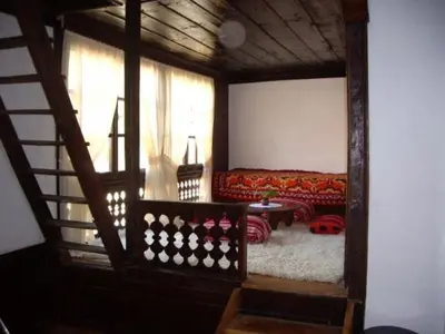a living room with a couch and a table at Popsokol House in Bratsigovo