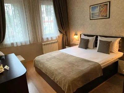 a bedroom with a large bed in a room at GM Royal Plaza in Borovets
