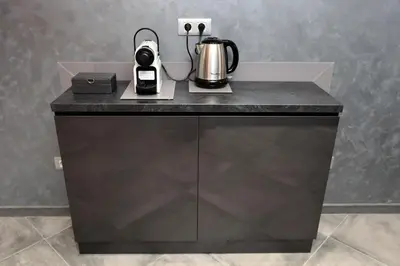a black counter with a coffee maker and a kettle on it at Silver Springs in Sofia
