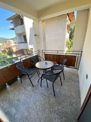 a balcony with a table and chairs on a balcony at Guest House Detelina in Devin