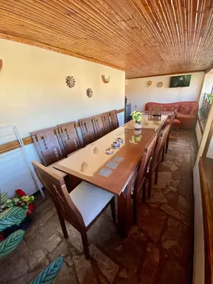 a dining room with a long table and chairs at Guest House Detelina in Devin