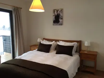 a bedroom with a large bed with white sheets and pillows at Chalet Mechka in Borovets