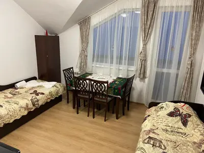 a room with a table and chairs and a bed at Ski Apartment Boyika Iglika 2 in Borovets