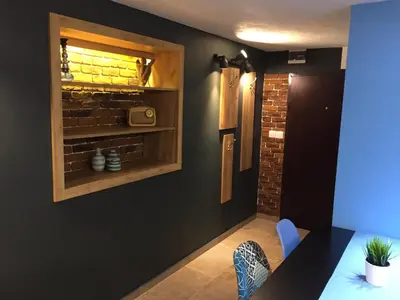 a dining room with black walls and a brick wall at City Garden Studio in Plovdiv
