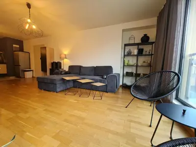 a living room with a couch and a table and chairs at Baratero Club Apartments Private Parking EV points in Sofia