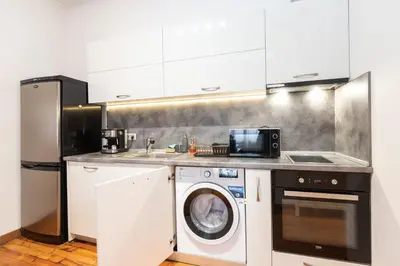 a kitchen with a washing machine and a washer at Rentapart Step in Sofia