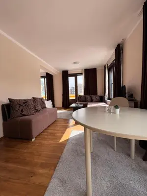 a living room with a couch and a table at Apartments Black Horse in Pamporovo