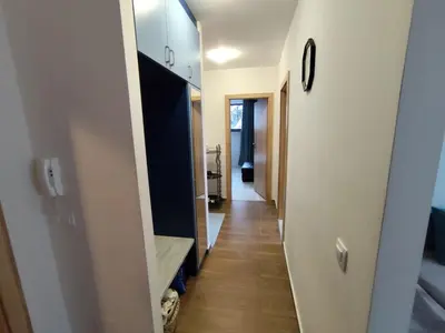 a hallway leading into a room with a mirror at Denitsa Apartment in Borovets