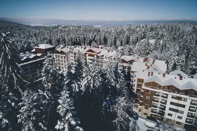 an aerial view of a resort with snow covered trees at Denitsa Apartment in Borovets