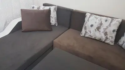 a couch with two pillows on top of it at Ayberk Apart Sandanski in Sandanski