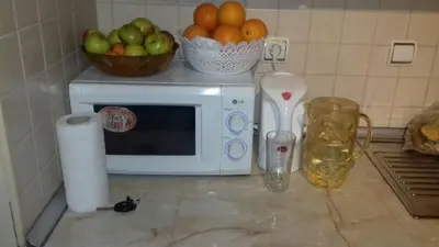 a kitchen counter with a microwave and a bowl of fruit at Manastira 2 apt Emo Pamporovo in Pamporovo