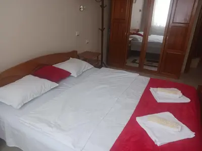 a bed with two towels on it with a mirror at Manastira 2 apt Emo Pamporovo in Pamporovo