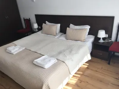 a bedroom with a large bed with two towels on it at Iglika 2 Ski Apartment in Borovets