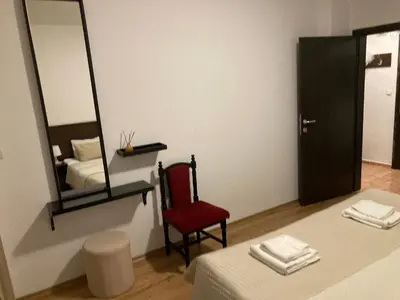 a room with a mirror and a red chair at Iglika 2 Ski Apartment in Borovets