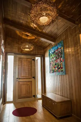 a room with a wooden wall with a bench and a painting at Villa Nataly at Golf Resort in Bansko