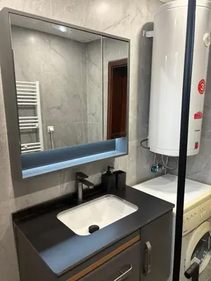 a bathroom with a sink and a mirror at Ramada 2 Boutique Apartment near Ski Road in Bansko