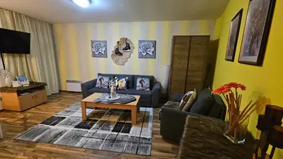 a living room with a couch and a coffee table at Ramada 2 Boutique Apartment near Ski Road in Bansko