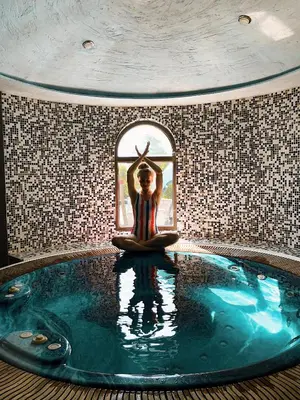 a woman doing a meditation in a swimming pool at Royal Valentina Castle in Ognyanovo