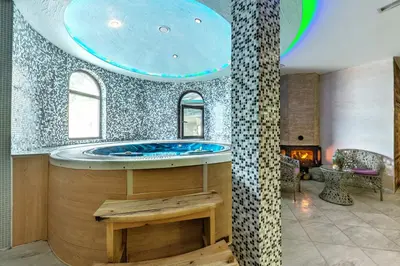 a large bathroom with a tub in the middle of a room at Royal Valentina Castle in Ognyanovo