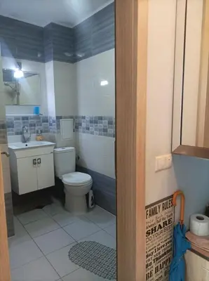 a bathroom with a toilet and a sink at Central Studio Maritsa in Plovdiv