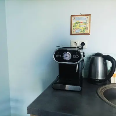 a coffee machine sitting on a counter next to a sink at Central Studio Maritsa in Plovdiv