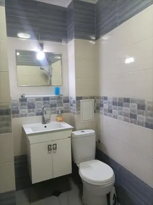 a bathroom with a white toilet and a sink at Central Studio Maritsa in Plovdiv