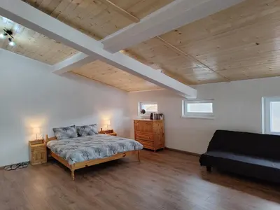 a large bedroom with a bed and a couch at Lakeview-Estate ApartHotel in Staro Myasto