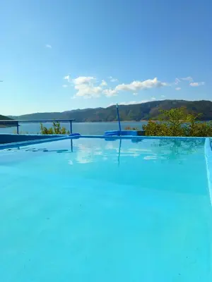 a swimming pool with a view of the water at Lakeview-Estate ApartHotel in Staro Myasto