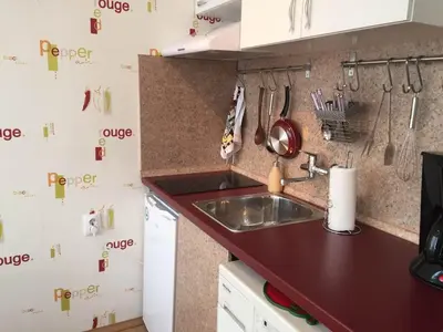a kitchen with a sink and a counter top at Airport Apartment in Sofia