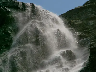a waterfall on the side of a mountain at Бунгала Говедарци in Govedartsi