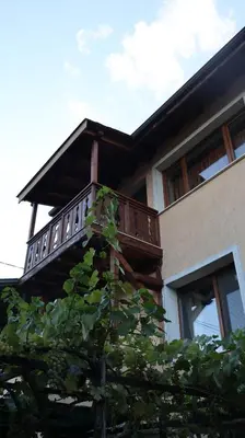 a house with a balcony on top of a tree at Valevitsata Guesthouse in Razlog