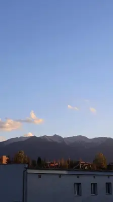 a view of a building with mountains in the background at Valevitsata Guesthouse in Razlog