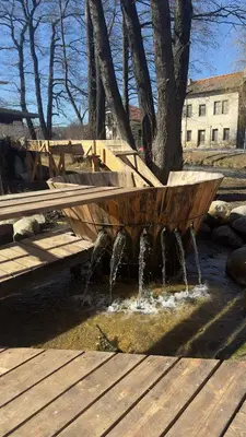 a wooden boat sitting on top of a fountain at Valevitsata Guesthouse in Razlog