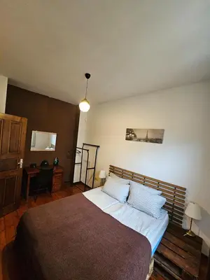 a bedroom with a large bed and a desk at Hot Spot Apartments in Sofia