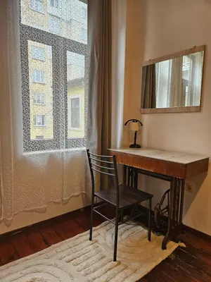 a desk with a chair next to a window at Hot Spot Apartments in Sofia
