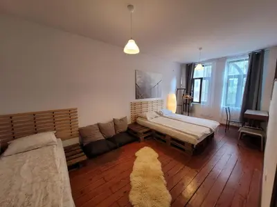 a living room with a bed and a couch at Hot Spot Apartments in Sofia