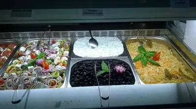 a tray of food with different types of food at Balneo & SPA Hotel Aura in Velingrad